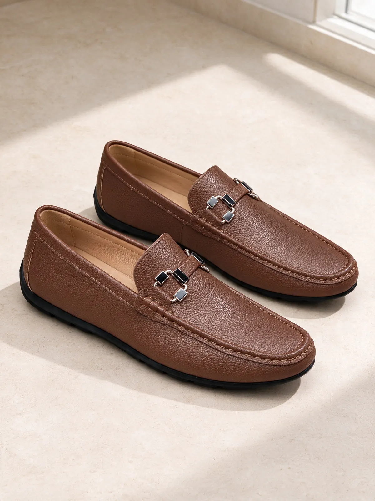 The Grand Tour Loafer, a Marcel Afters style, photographed on limestone.