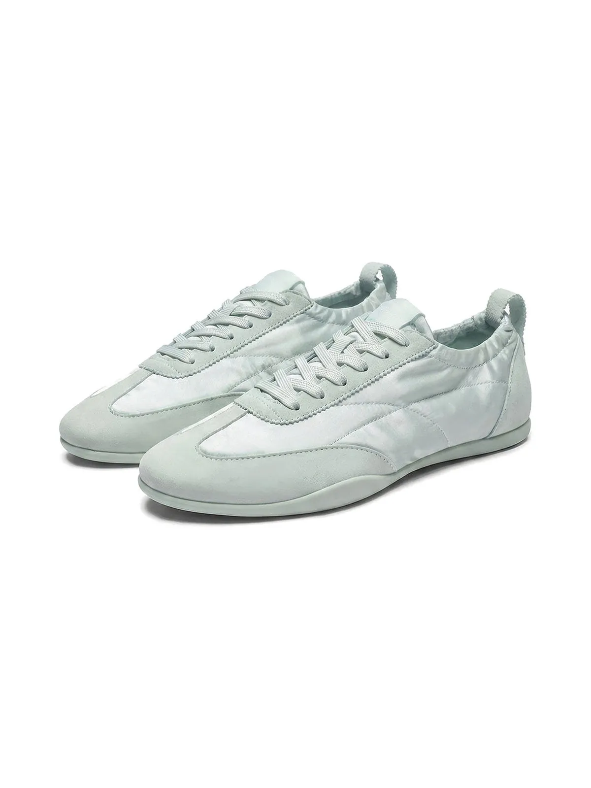 The Rehearsal Sneaker in pale sage, a pair on white.